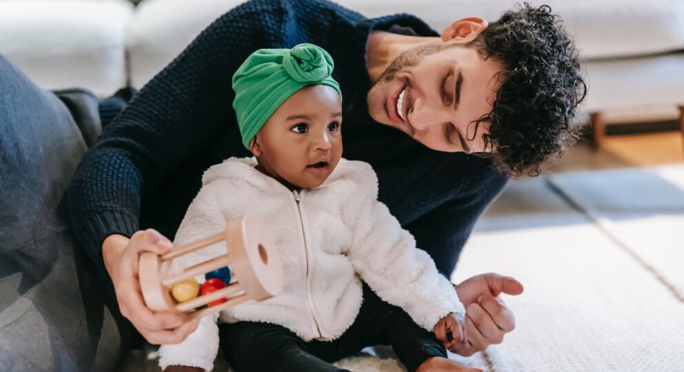 image of parent with baby, smiling and laughing.