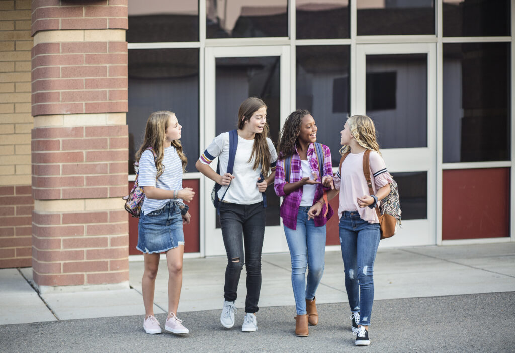 Teen girls socializing and being inclusive at school