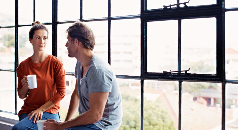 Image of couple talking. How to listen without becoming defensive.