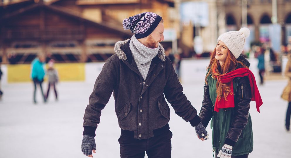 image of couple on a date ice skating.