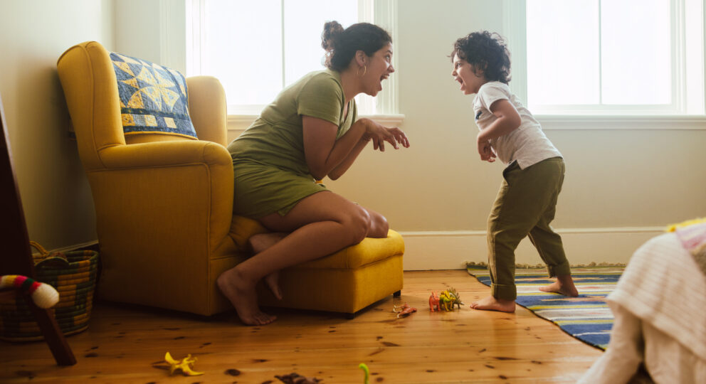 Mother and son engaging in pretend dinosaur play